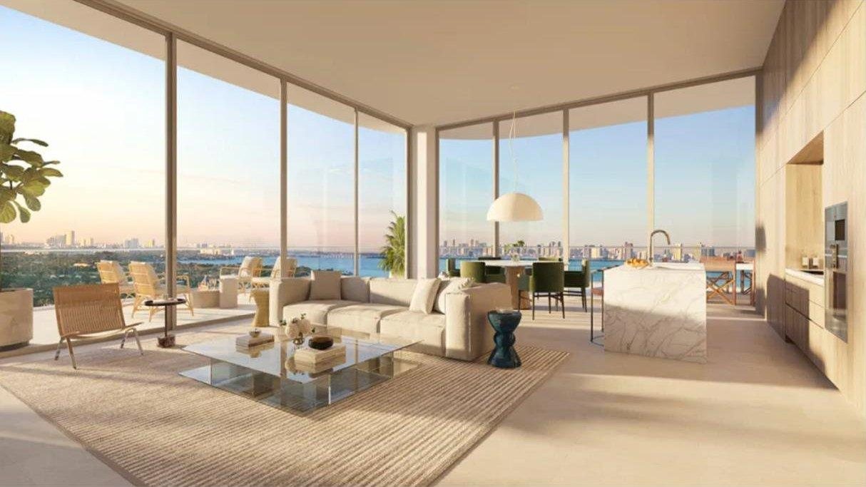 72 Carlyle Miami Beach residence great room rendering with floor-to-ceiling sliding glass doors opening to a wraparound terrace over Biscayne Bay