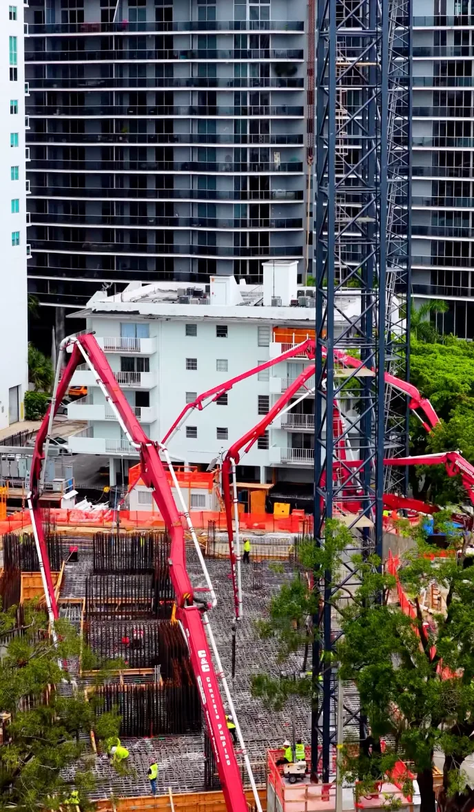 Concrete pump booms placing the mat slab over rebar at Edge House Miami, Edgewater