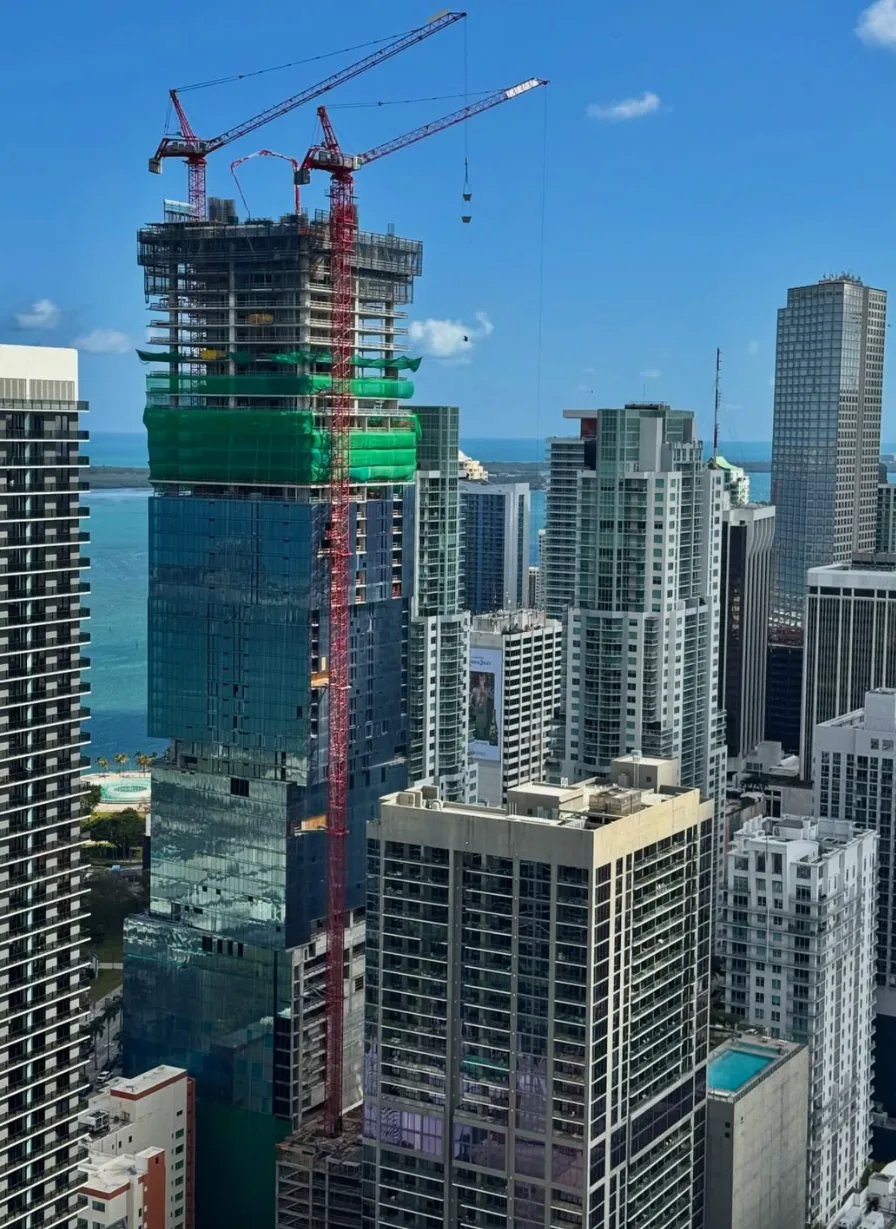 Waldorf Astoria Residences Miami under construction, stacked glass cubes above Biscayne Bay, downtown Miami