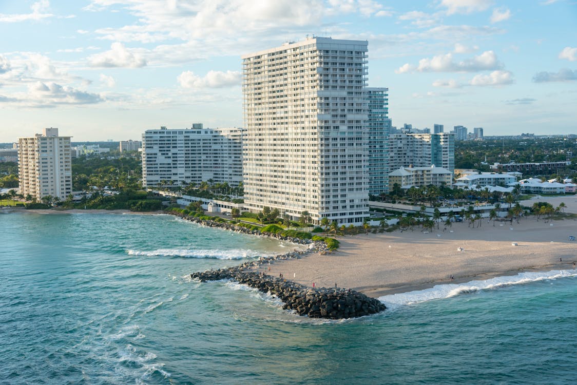 Aerial view of Bal Harbour oceanfront luxury condo towers with rock jetty inlet illustrating the waterfront single-family land value comp set the 220 Bal Bay Drive $31M teardown closing established on May 18, 2026