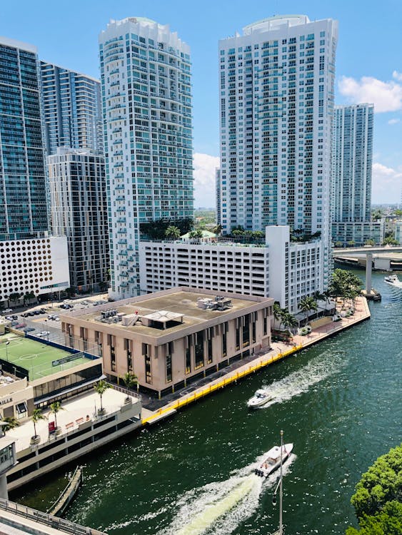 Waterfront rendering of Una Residences with a yacht at sunset in Brickell