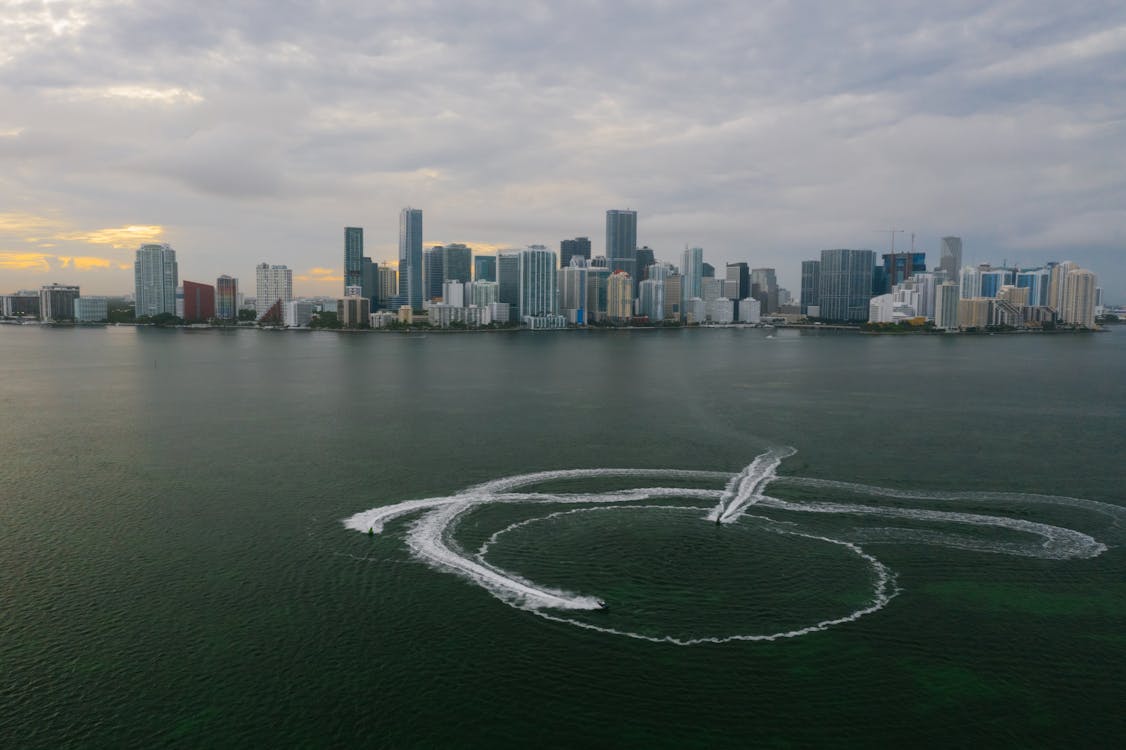 Aerial view of the Miami bayfront skyline over Biscayne Bay, where buyout-driven redevelopment is reshaping prime waterfront neighborhoods