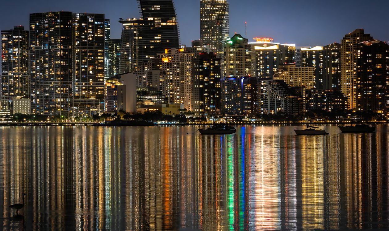 Brickell and downtown Miami skyline of luxury condo towers at night, the preconstruction market where deposits are locked for years before delivery
