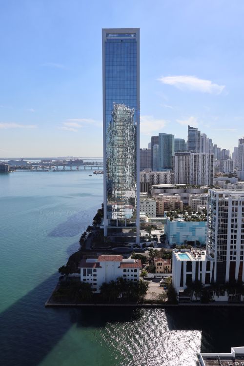 Slender glass boutique condo tower on the Miami waterfront, illustrating Aventura's boutique development trend in 2026