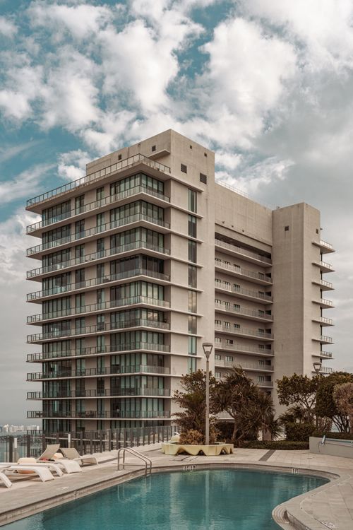Oceanfront luxury condo tower with pool deck in Surfside, Miami, representing branded residences like the Surf Club Four Seasons