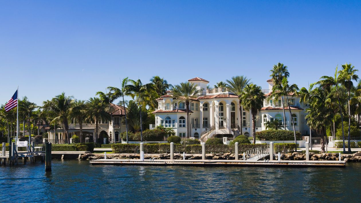 Waterfront luxury mansion with private dock on a Miami island, the property type that led July 2026 luxury contract activity