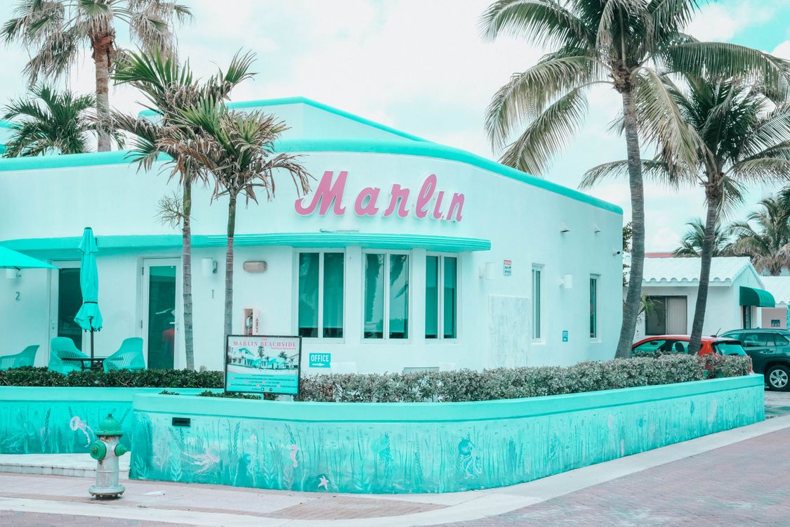 Edificio de estilo Art Deco frente a la playa con palmeras en Hollywood Beach, Florida