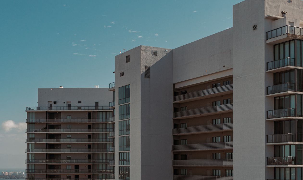 Balconies on a Miami condo tower, illustrating that a buyer owns a unit plus a share of defined common elements and nothing beyond them