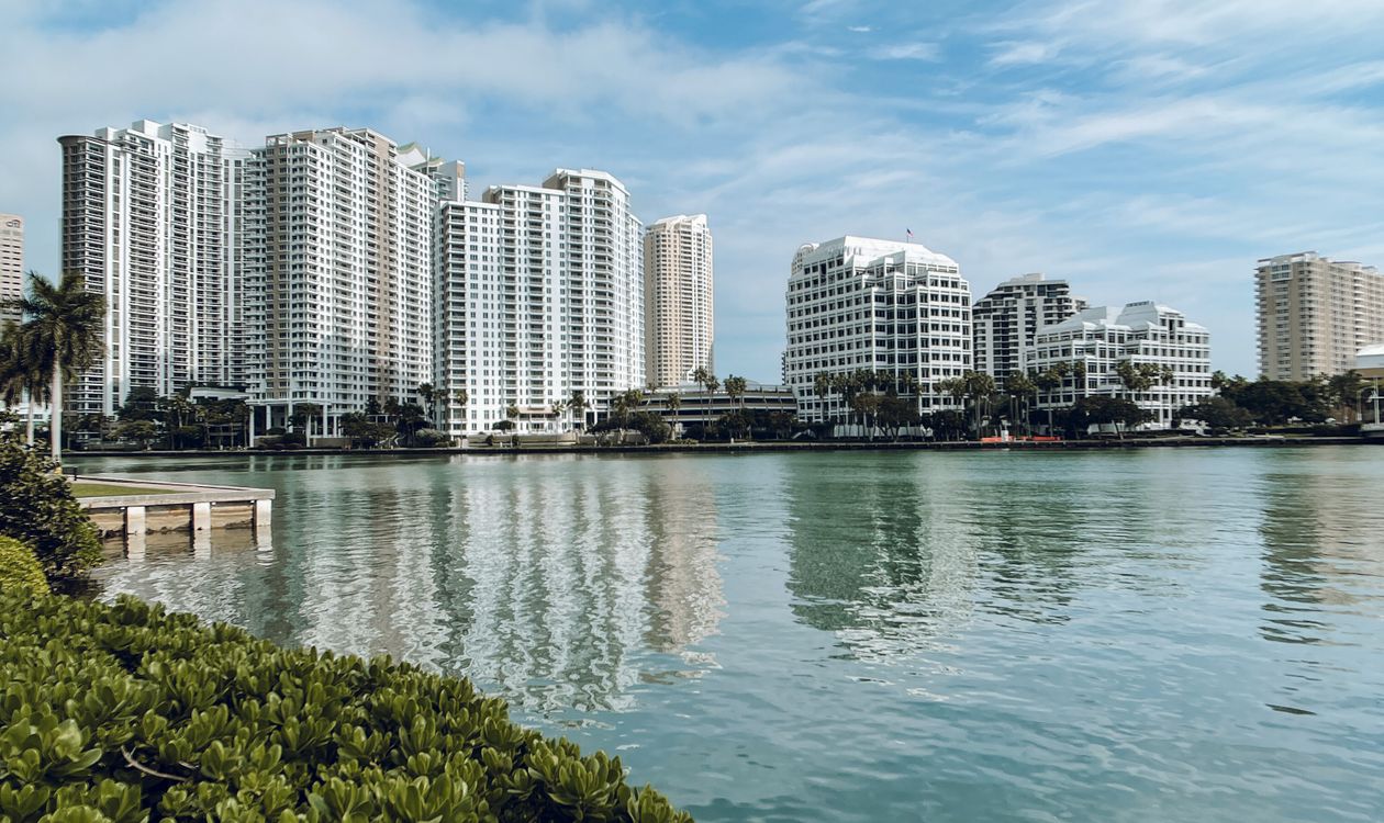 Miami waterfront condo towers across the bay, the kind of amenity-rich enclave where adjacent land ownership decides future development risk