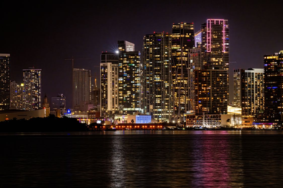 Torres de condomínios de luxo de Brickell e Edgewater iluminadas à noite sobre a baía de Biscayne em Miami