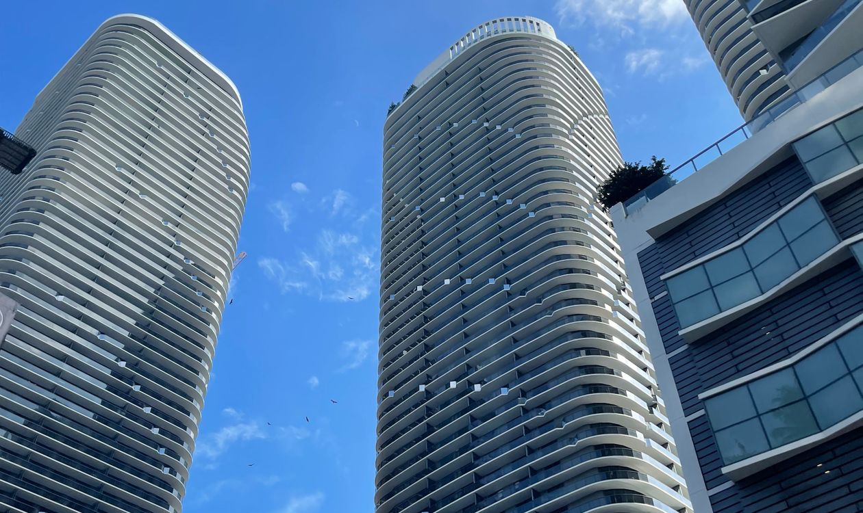 Miami condominium towers seen from street level, the buildings now subject to Full Review under the August 2026 Fannie Mae condo lending rules