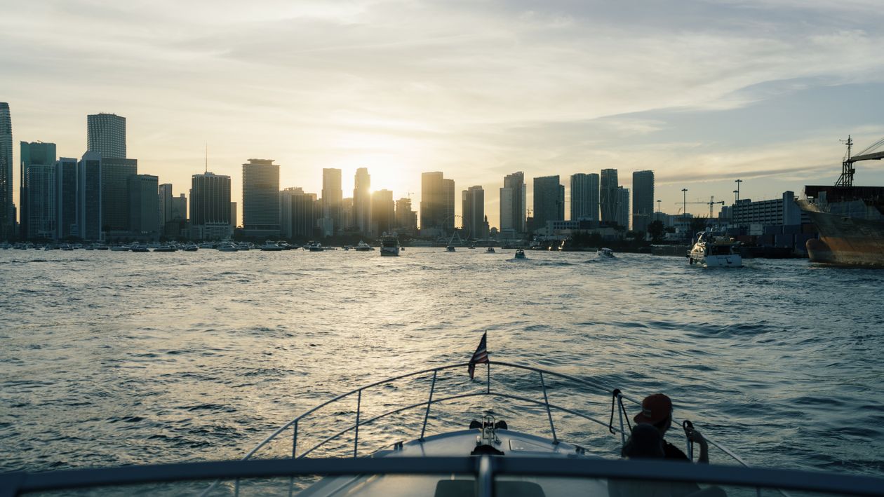 View of the Miami skyline at sunset from the bow of a boat on Biscayne Bay near the port