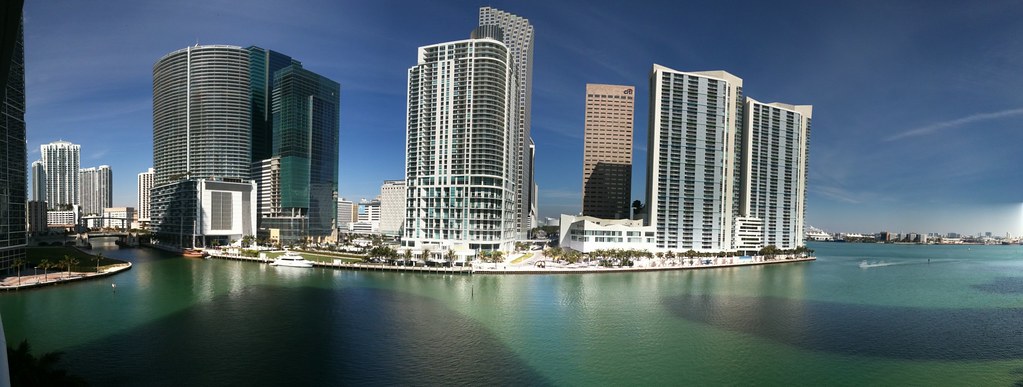 Aerial view of the Brickell financial district skyline with glass luxury condo towers along Biscayne Bay in Miami