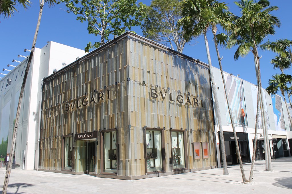 Bronze-clad Bulgari flagship store surrounded by palms in the Miami Design District