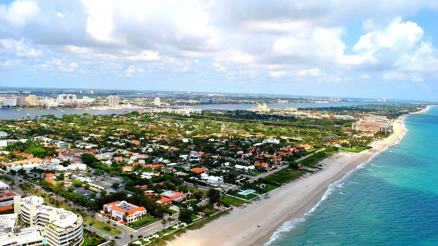 Aerial view of the Town of Palm Beach oceanfront with The Breakers, the Lake Worth Lagoon and West Palm Beach behind it, in Palm Beach County, Florida