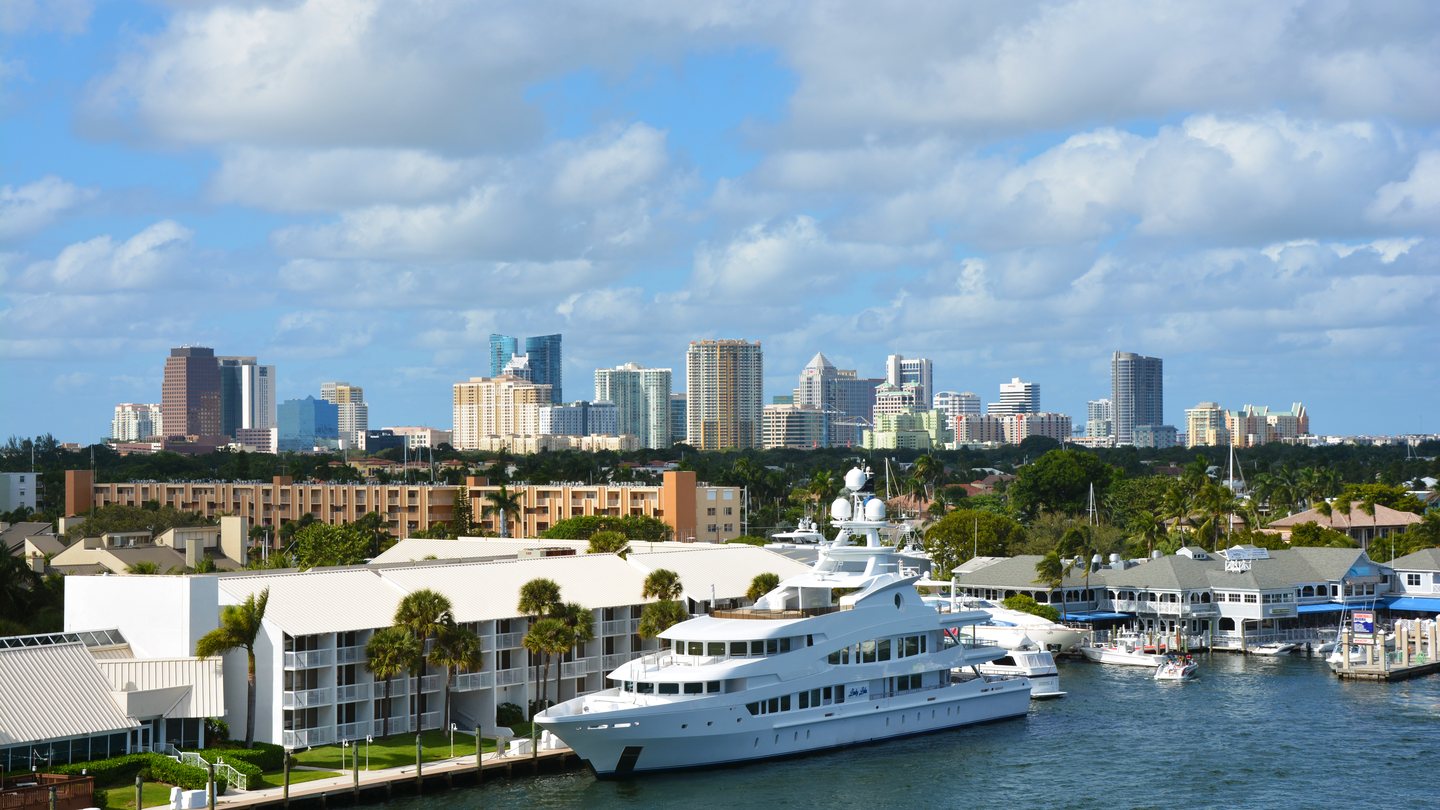 The Fort Lauderdale skyline seen over the Intracoastal Waterway with a yacht moored in the foreground
