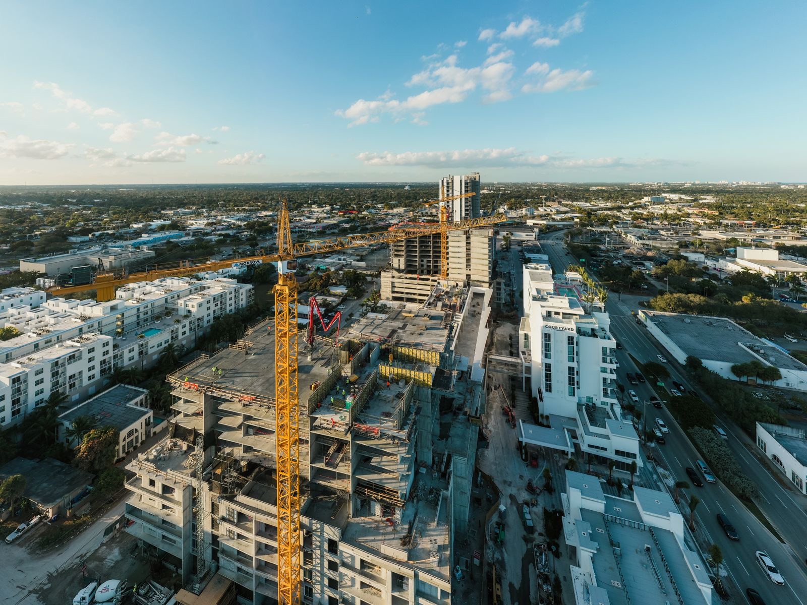 South Florida construction site with tower crane and unfinished high-rise building