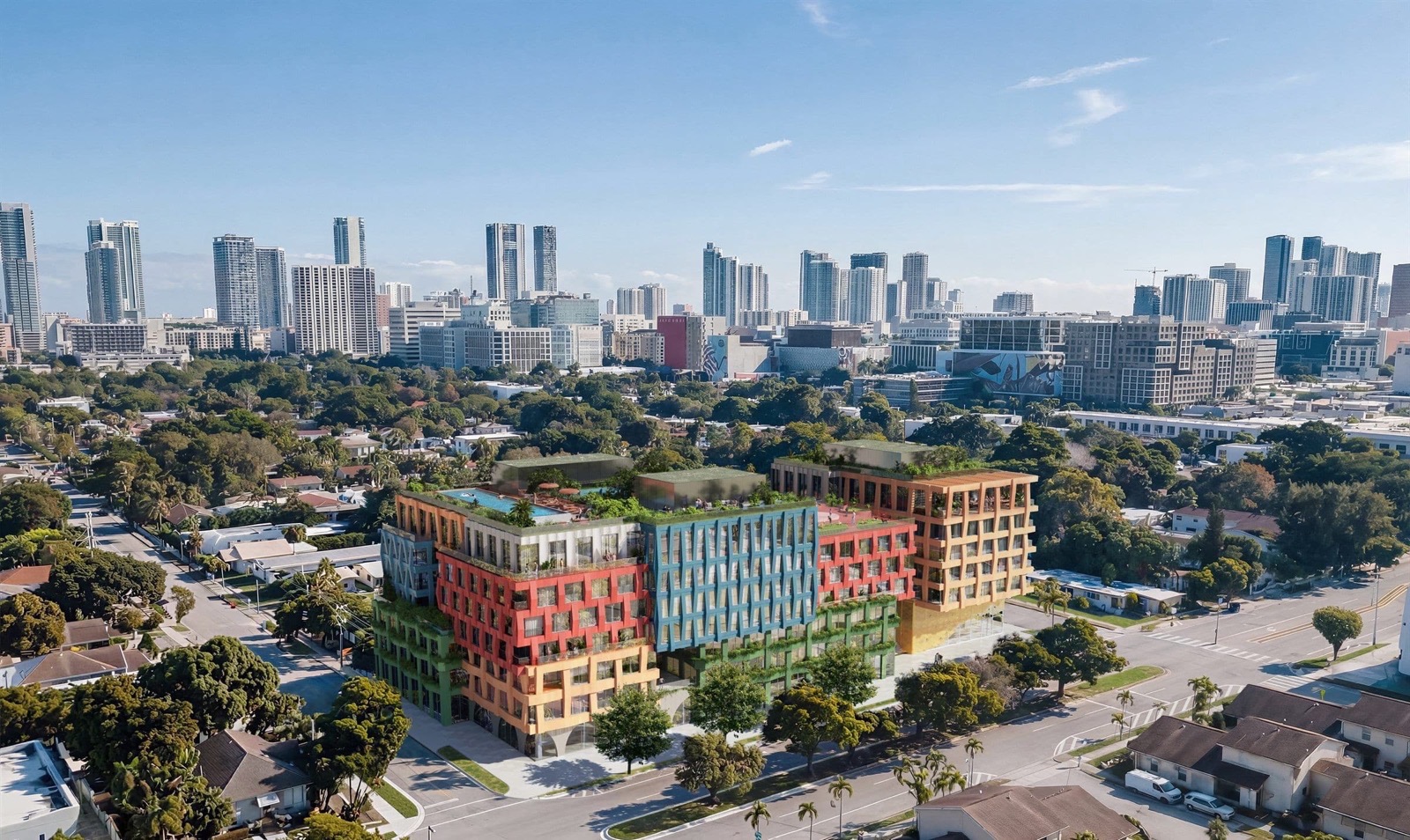 Renderizado oficial de WOMA Wynwood que muestra la fachada de bloques de color inspirada en textiles del edificio de 163 unidades en Wynwood Norte, Miami